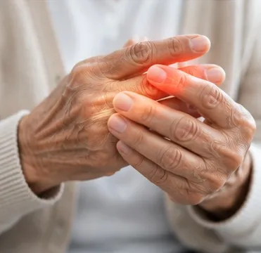 Older person rubbing painful finger joints